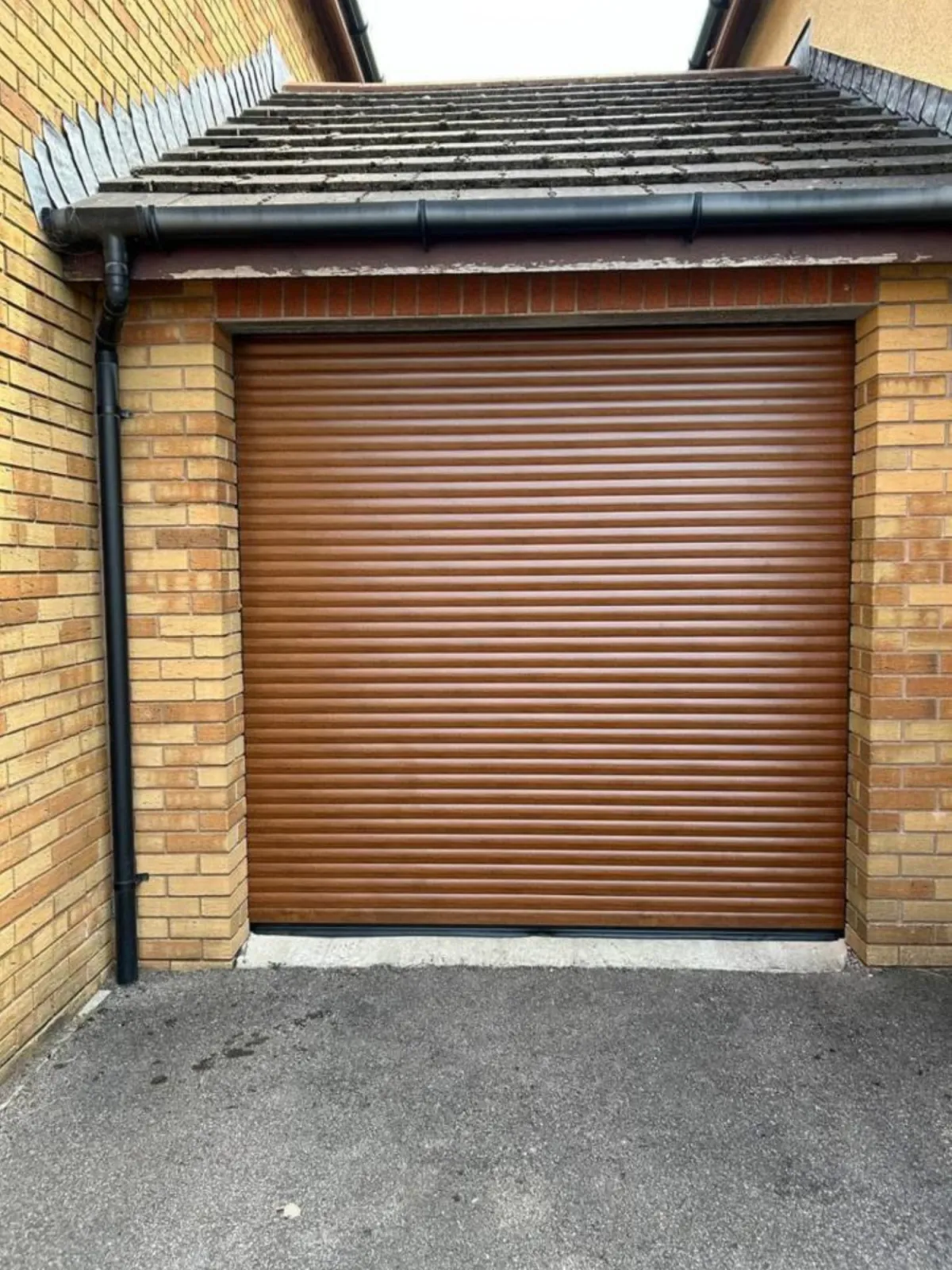 An oak coloured roller shutter door that we installed in Swansea