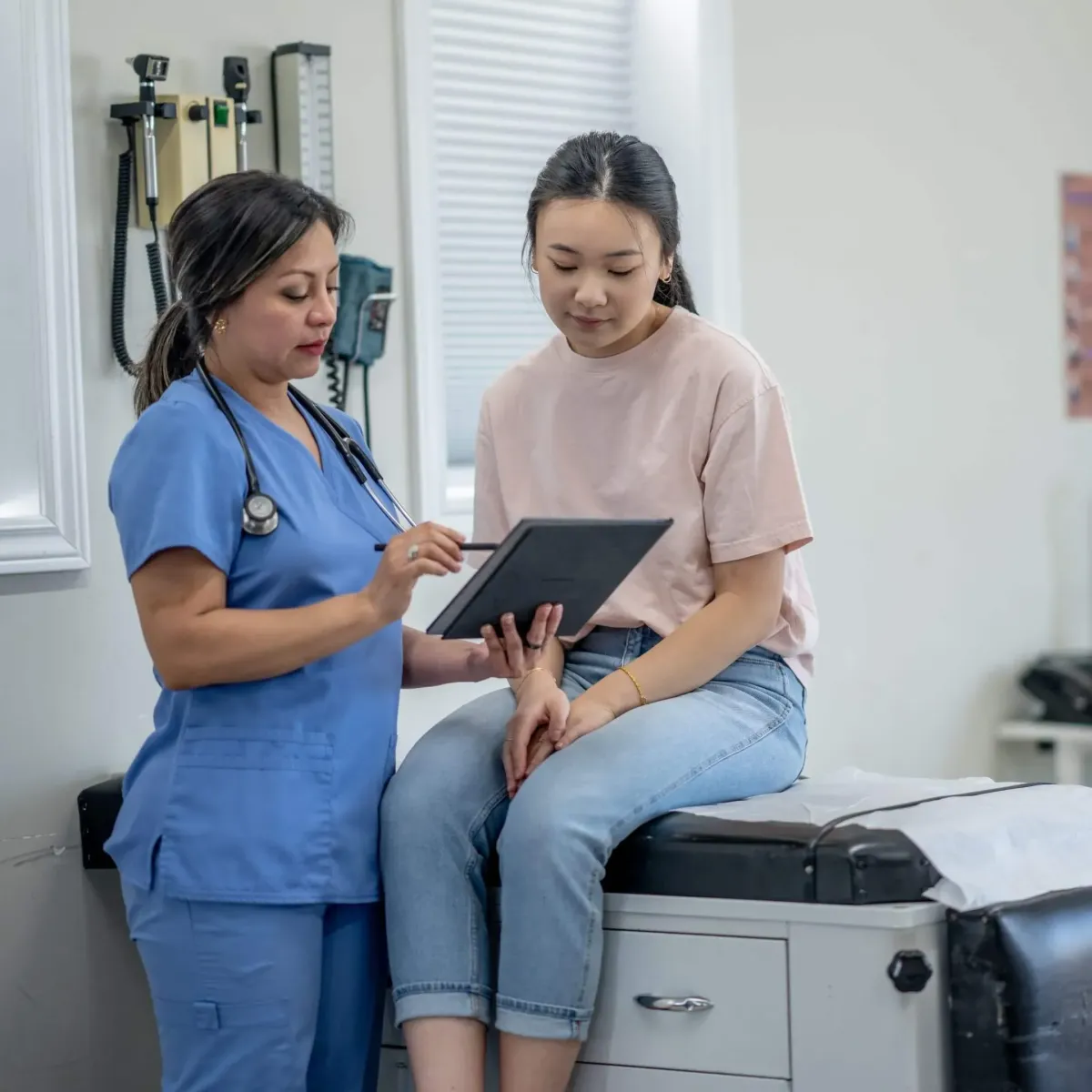 A young lady reviewing a chart with a nurse