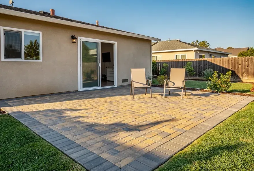 Finished paver patio attached to a modest home in Rosemead, California with outdoor seating