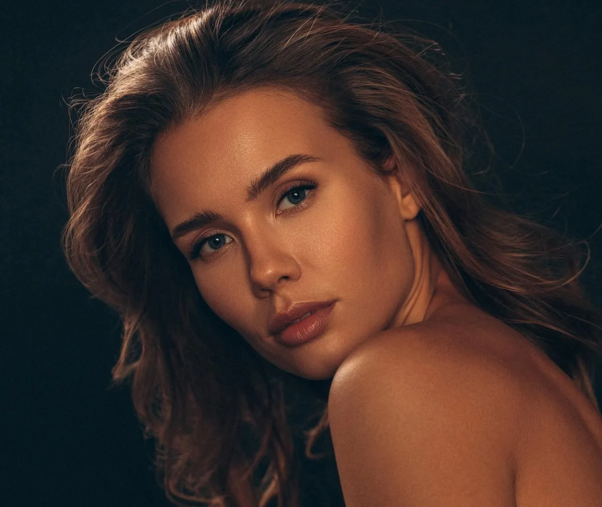 person in white dress shirt wearing green and white hat