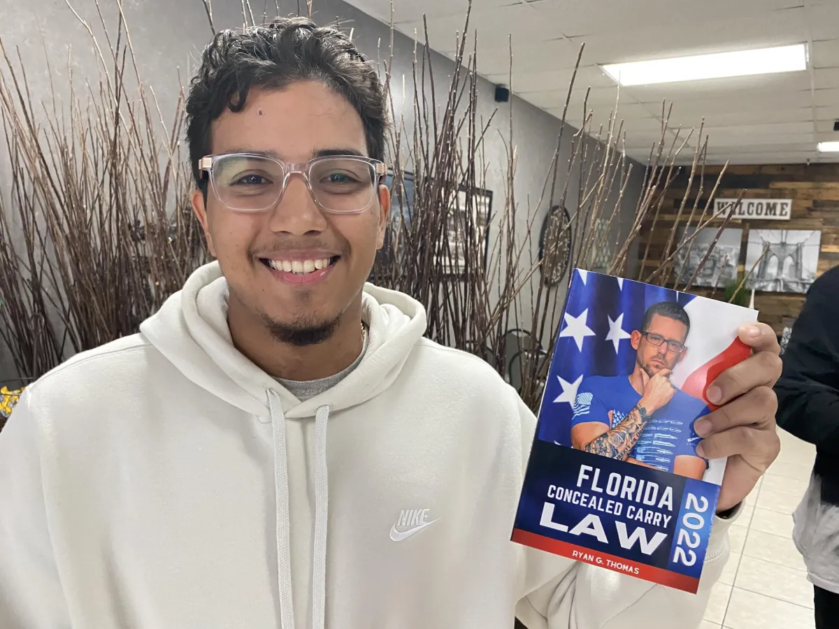 Man holding Florida Concealed Carry Law book