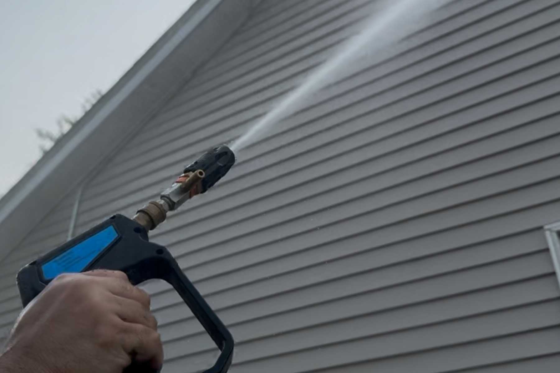 Soft washing vinyl siding on home exterior in Hudson Valley NY