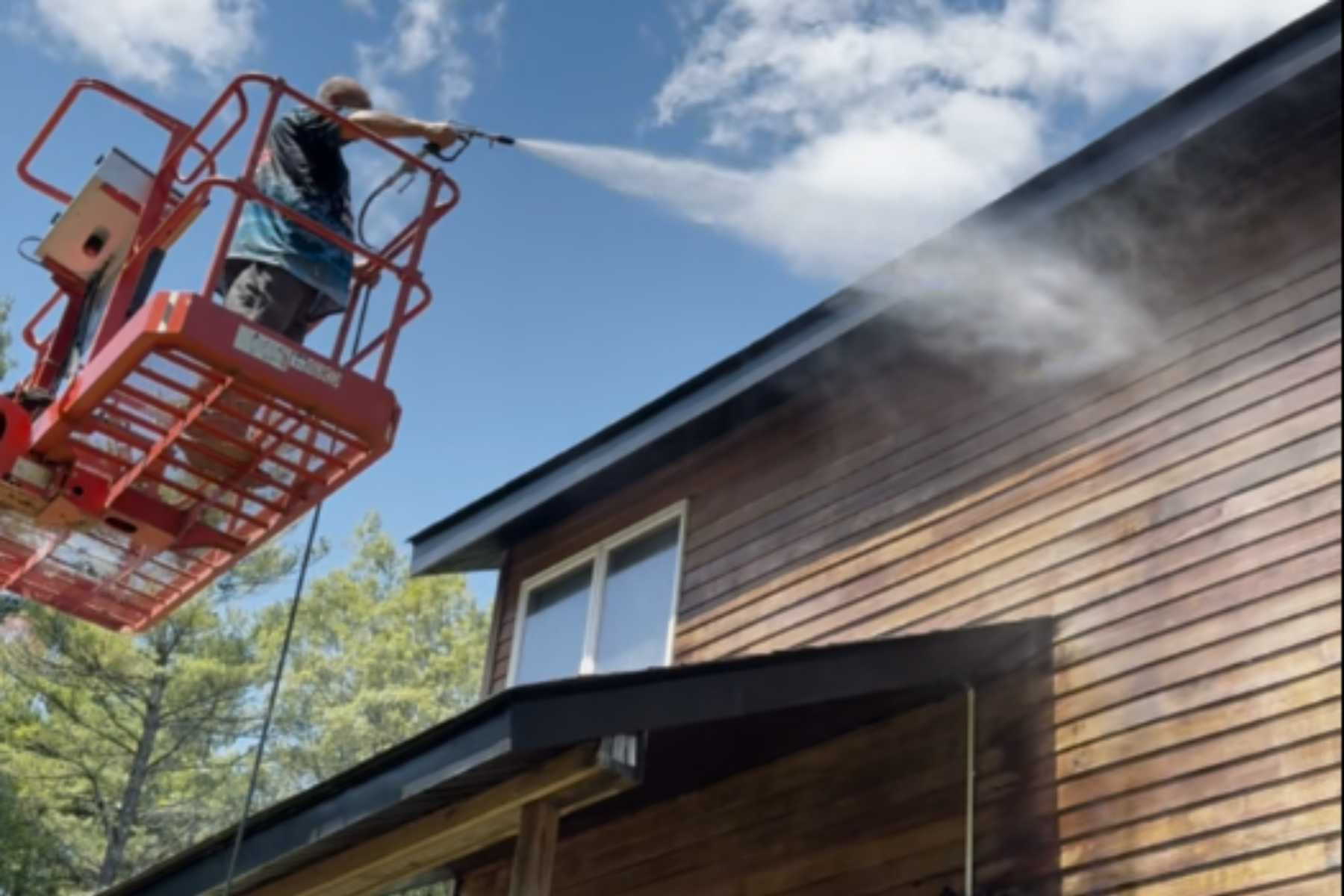 Professional cedar siding cleaning and restoration in West Saugerties, NY using a lift to soft-wash and brighten weathered wood on a Hudson Valley home.