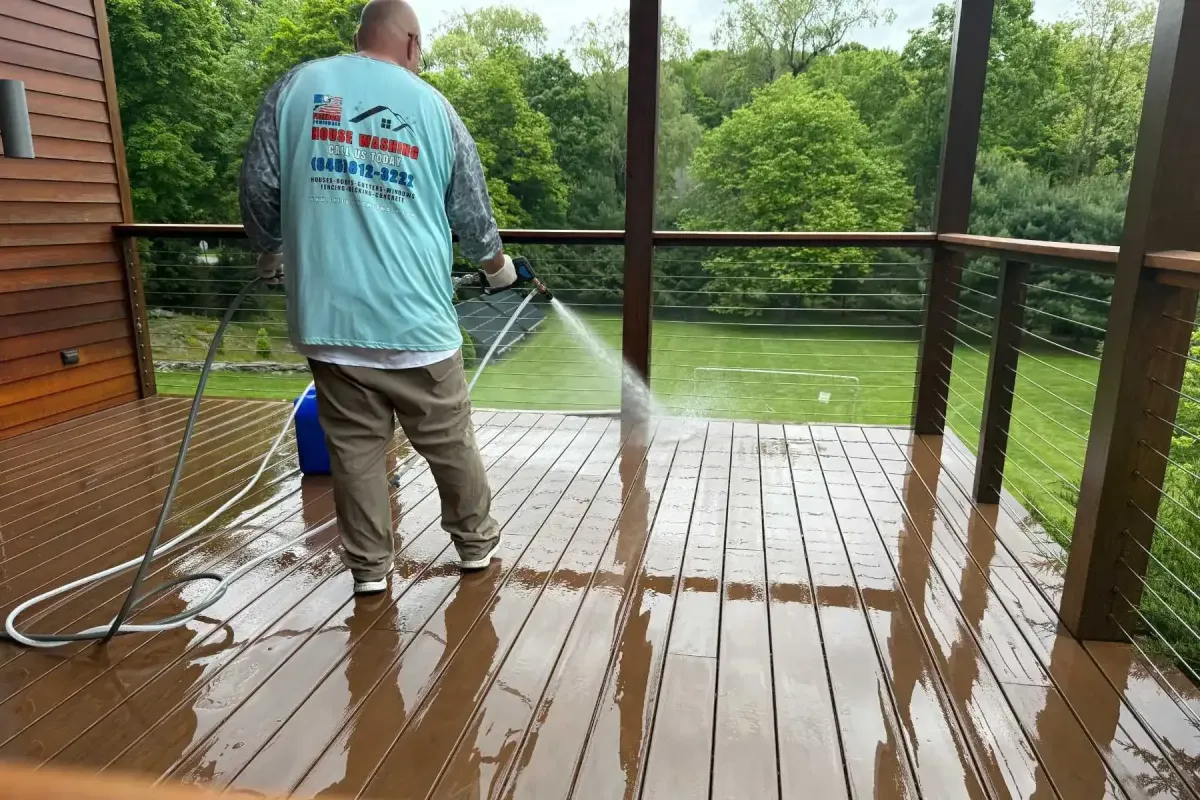 Professional deck soft washing in Milan, NY with the Freedom Powerwash owner using a low-pressure soft-wash rinse to clean and restore a composite deck.