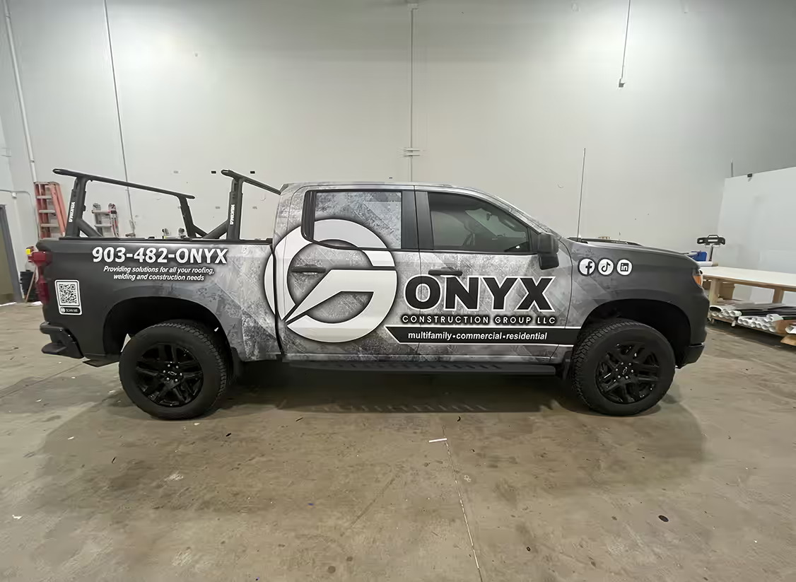 Dark grey Onyx Construction Group wrapped truck.