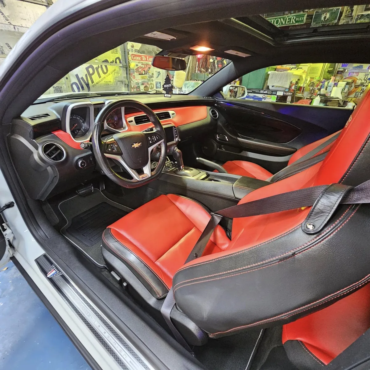 a white sports car parked in a garage