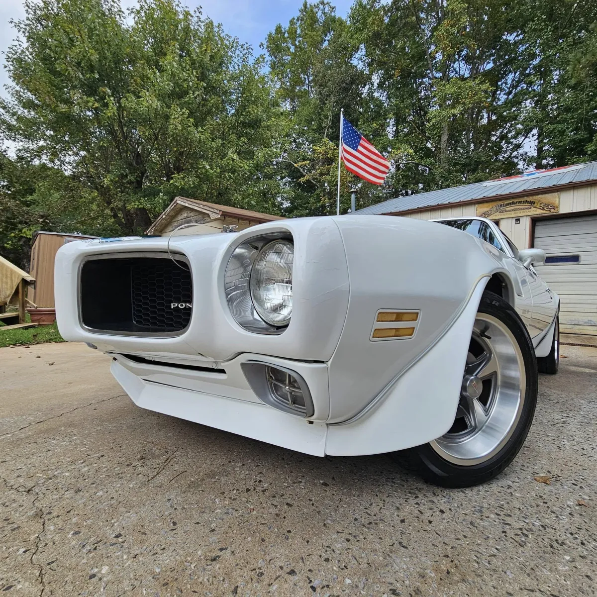 a white sports car parked in a garage