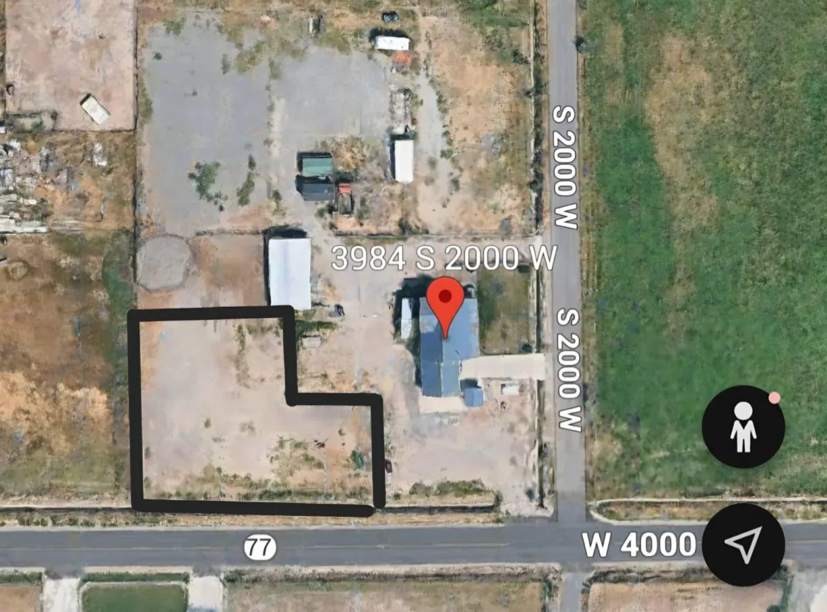 Vintage cars and motorcycles displayed in a large garage.