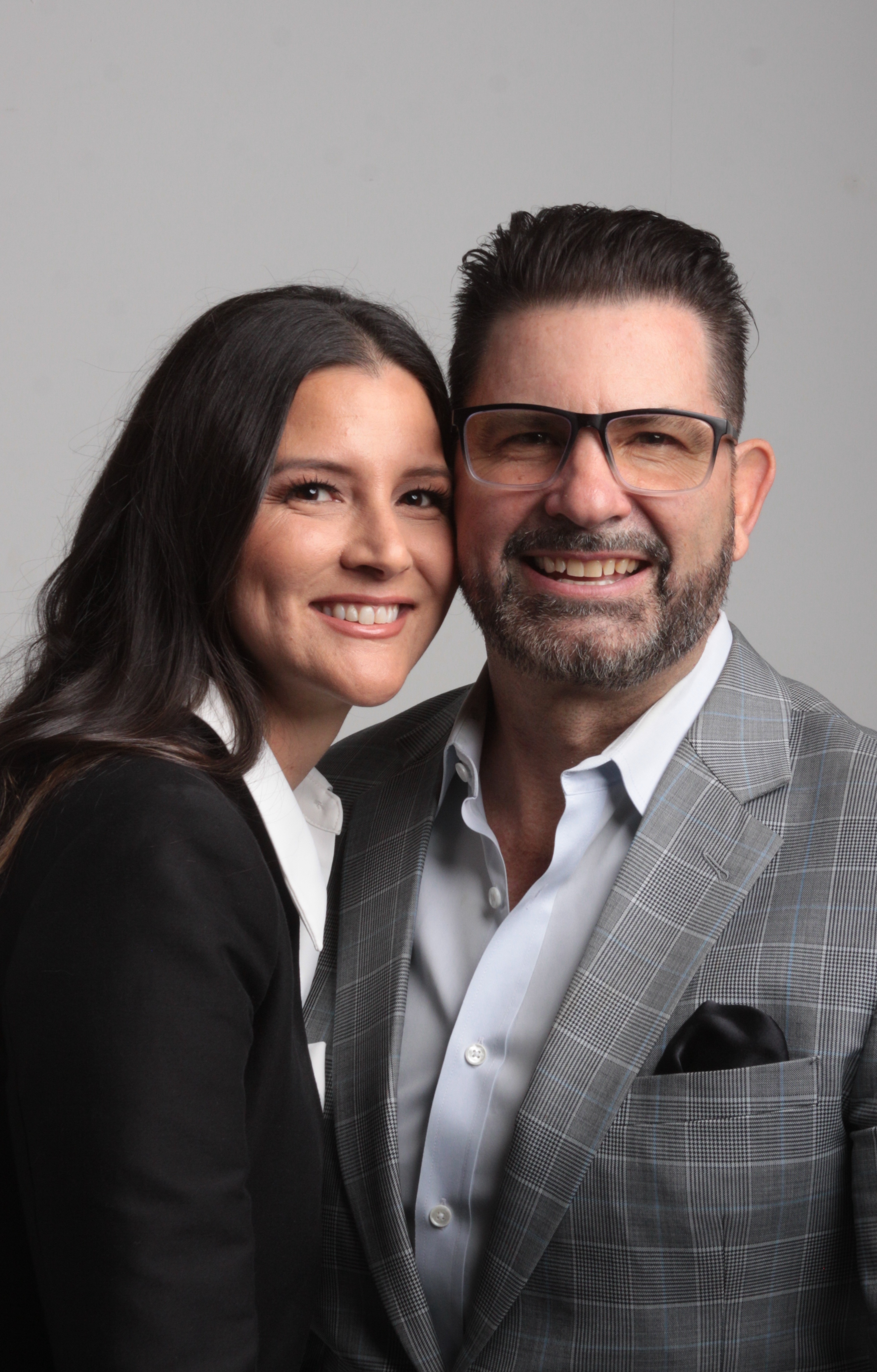 A charismatic middle-aged man with salt-and-pepper hair in a cozy library, warm and approachable.