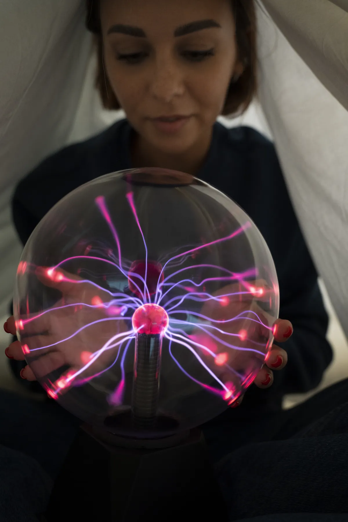 Woman holding a plasma ball representing Somatic EMDR and body-based emotional processing