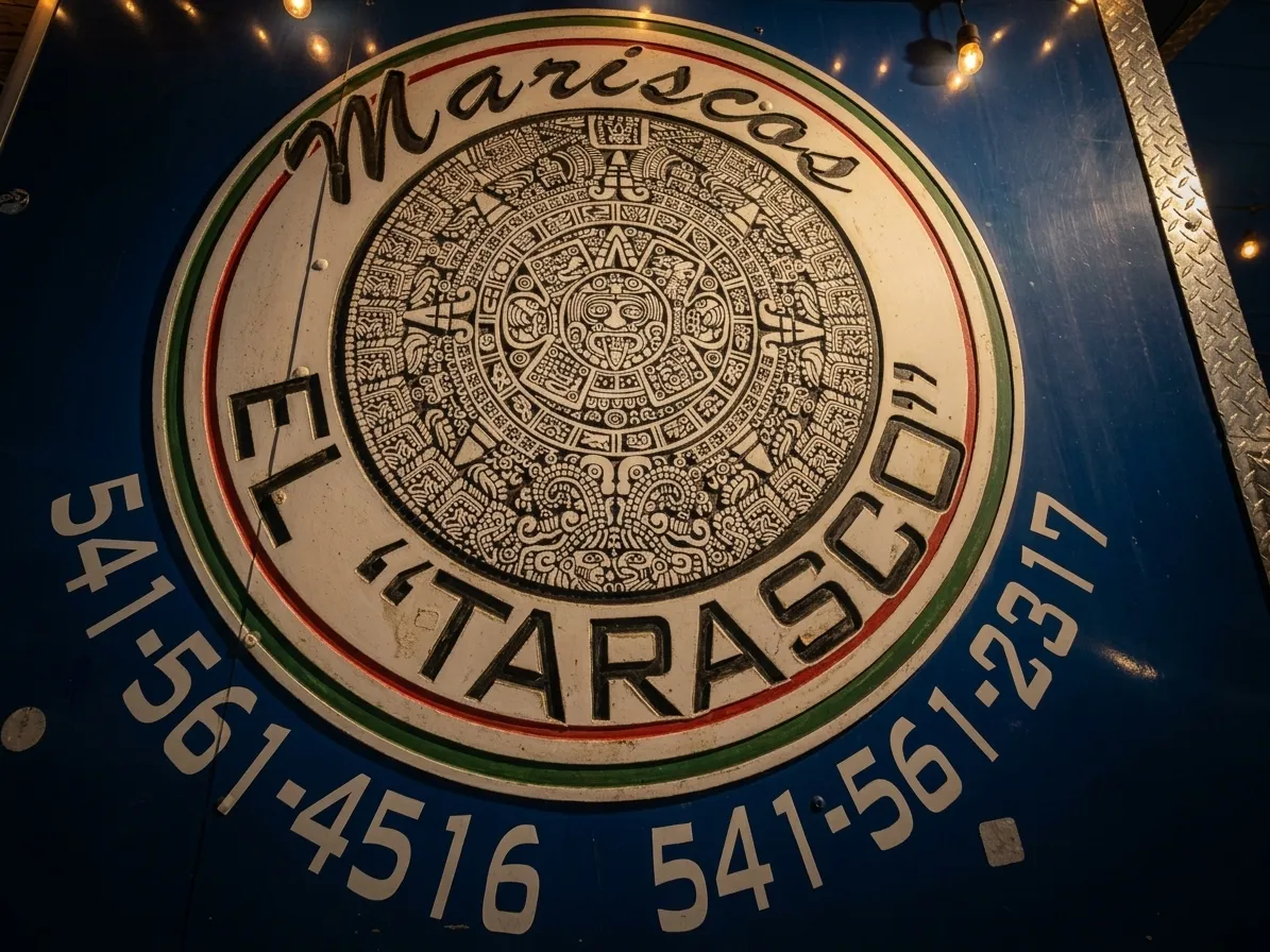 Warm dining room interior at Mariscos Al Tarasco with artisanal lighting and soft bokeh in Hermiston Oregon