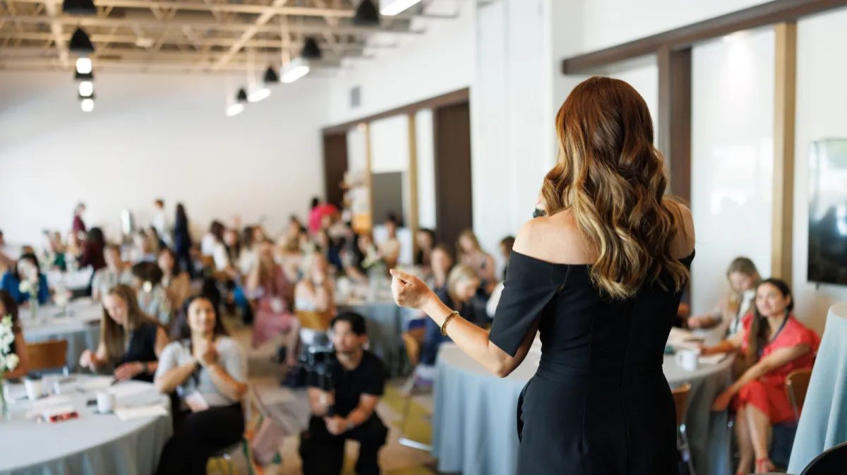 Maggie speaking to an audience