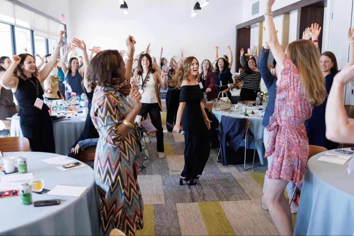 Health professionals celebrating at a live Online Business Academy™ event