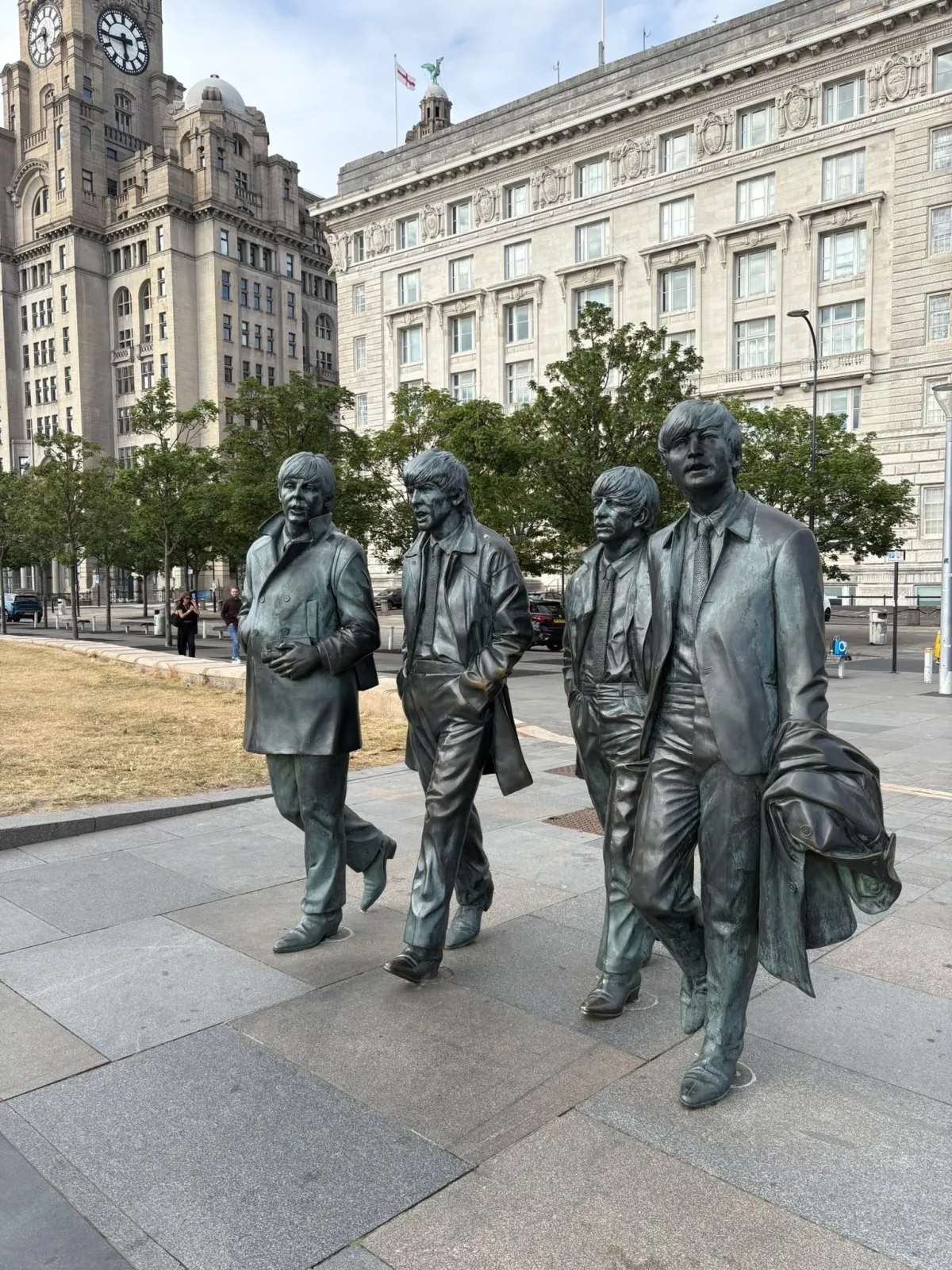 Bronze statues of four musical legends "The Beatles" in Liverpool, reflecting the city’s music history, creativity and lasting cultural spirit.