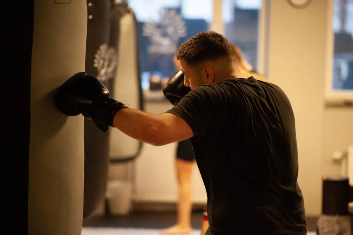 A man doing a push up on a blue mat
