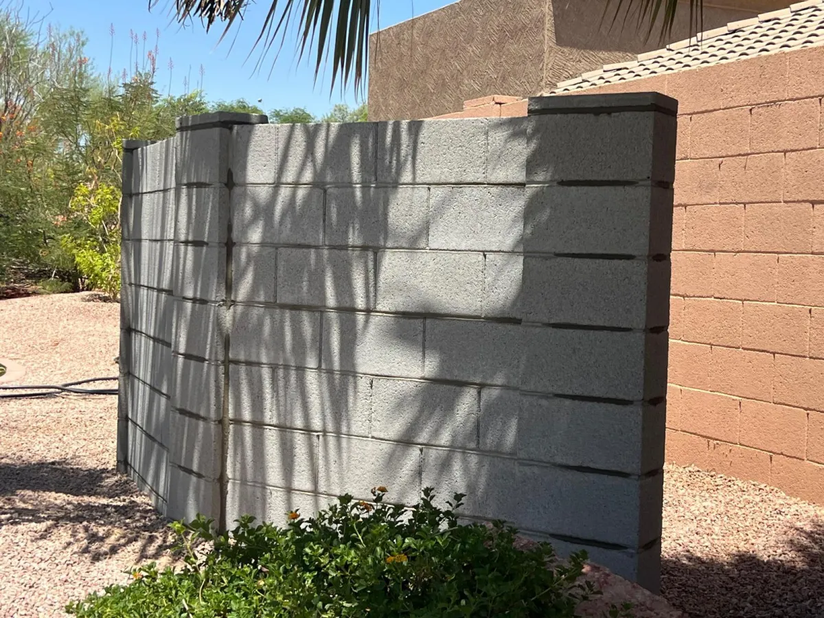 Completed gray concrete block wall with reinforced pillars in Phoenix, Arizona