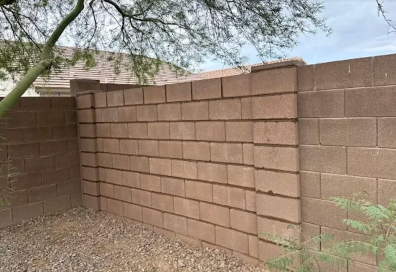 Repaired brown concrete block wall section in Phoenix, Arizona