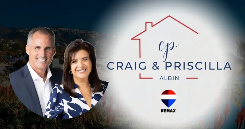 Craig & Priscilla Albin RE/MAX real estate team in a home setting