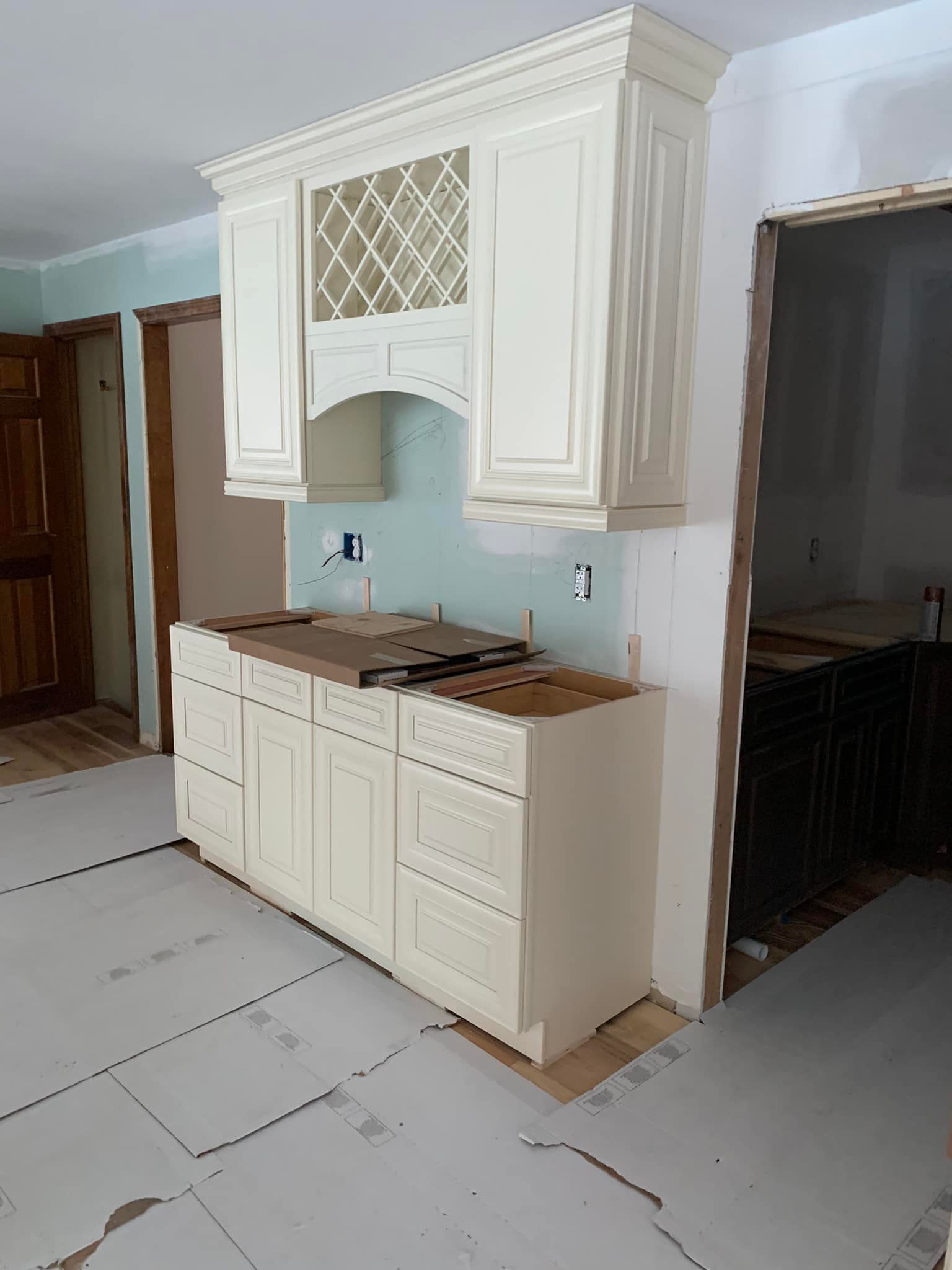 contractor installing kitchen cabinets and island unit