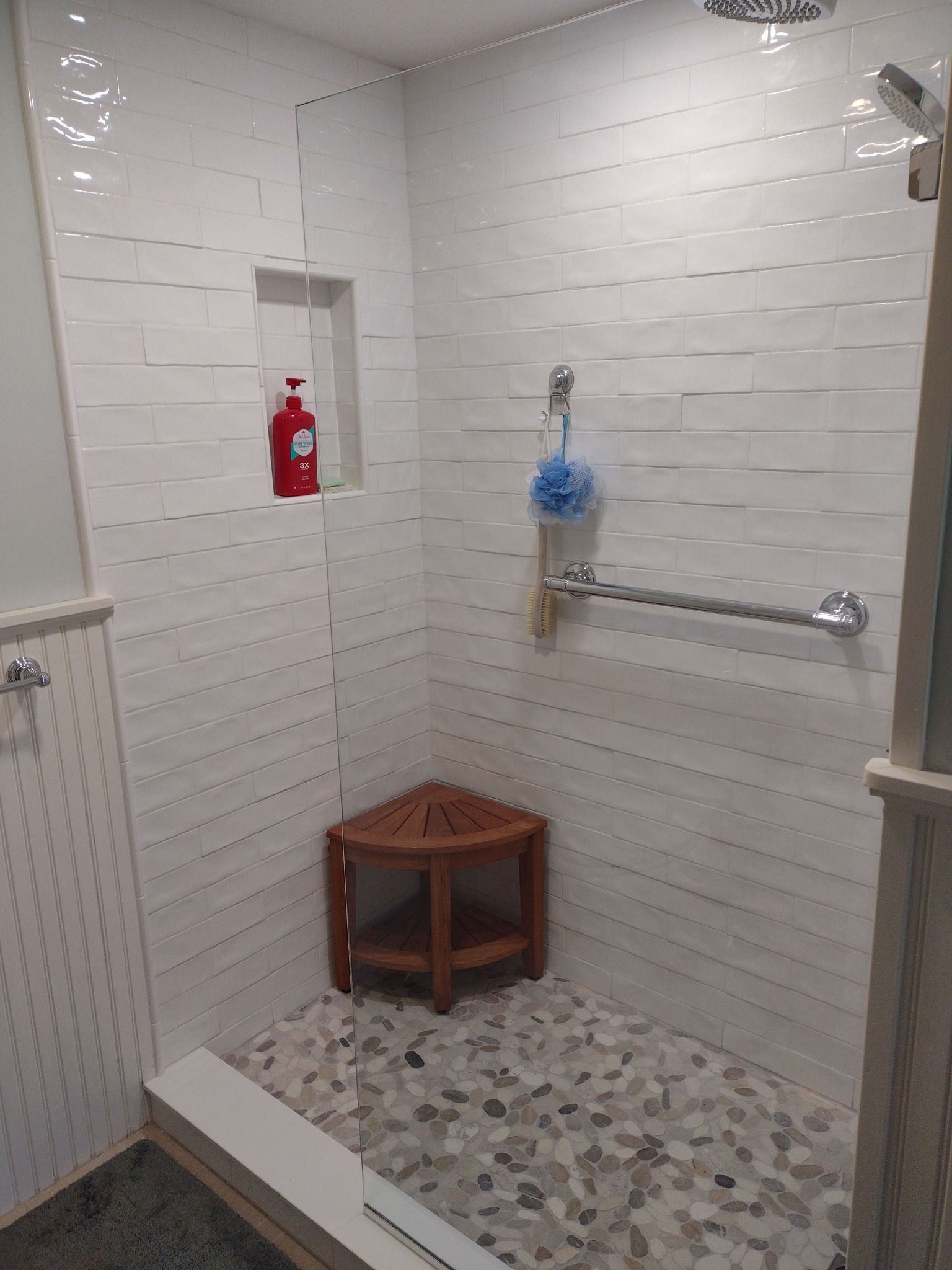 walk-in shower with glass enclosure and tiled walls