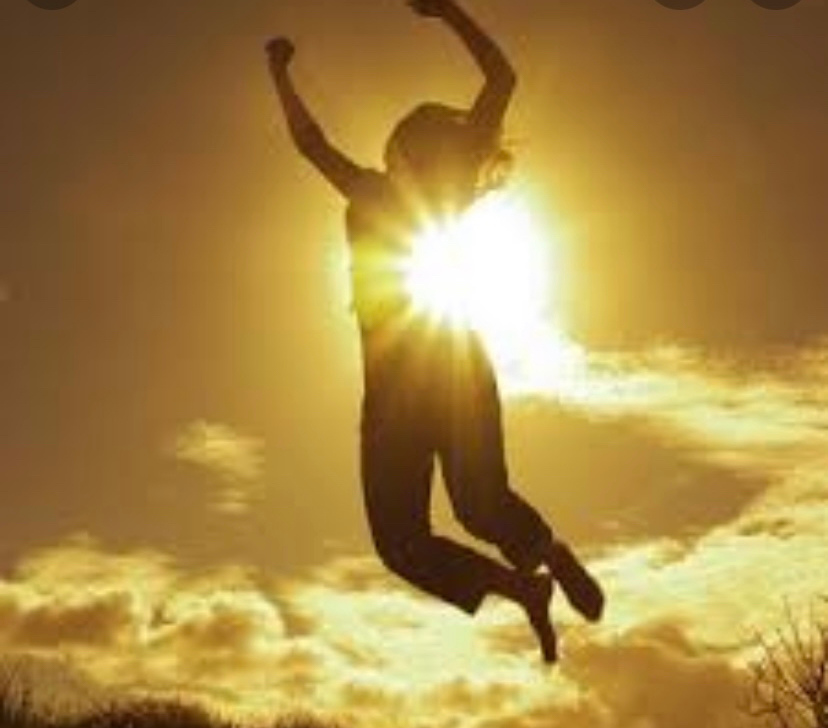 Stylish woman poses next to a reflective wall.