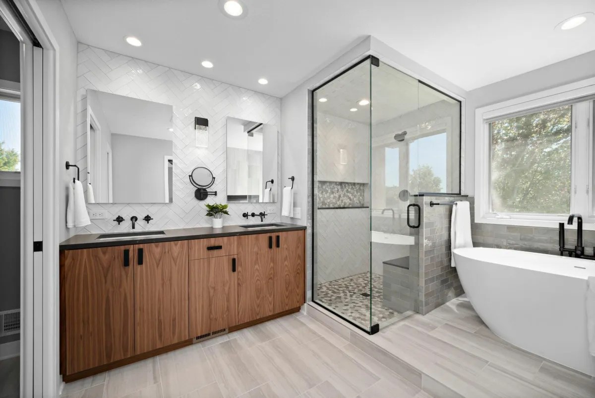 Modern bathroom with floating vanity, large walk-in shower, and neutral tile.