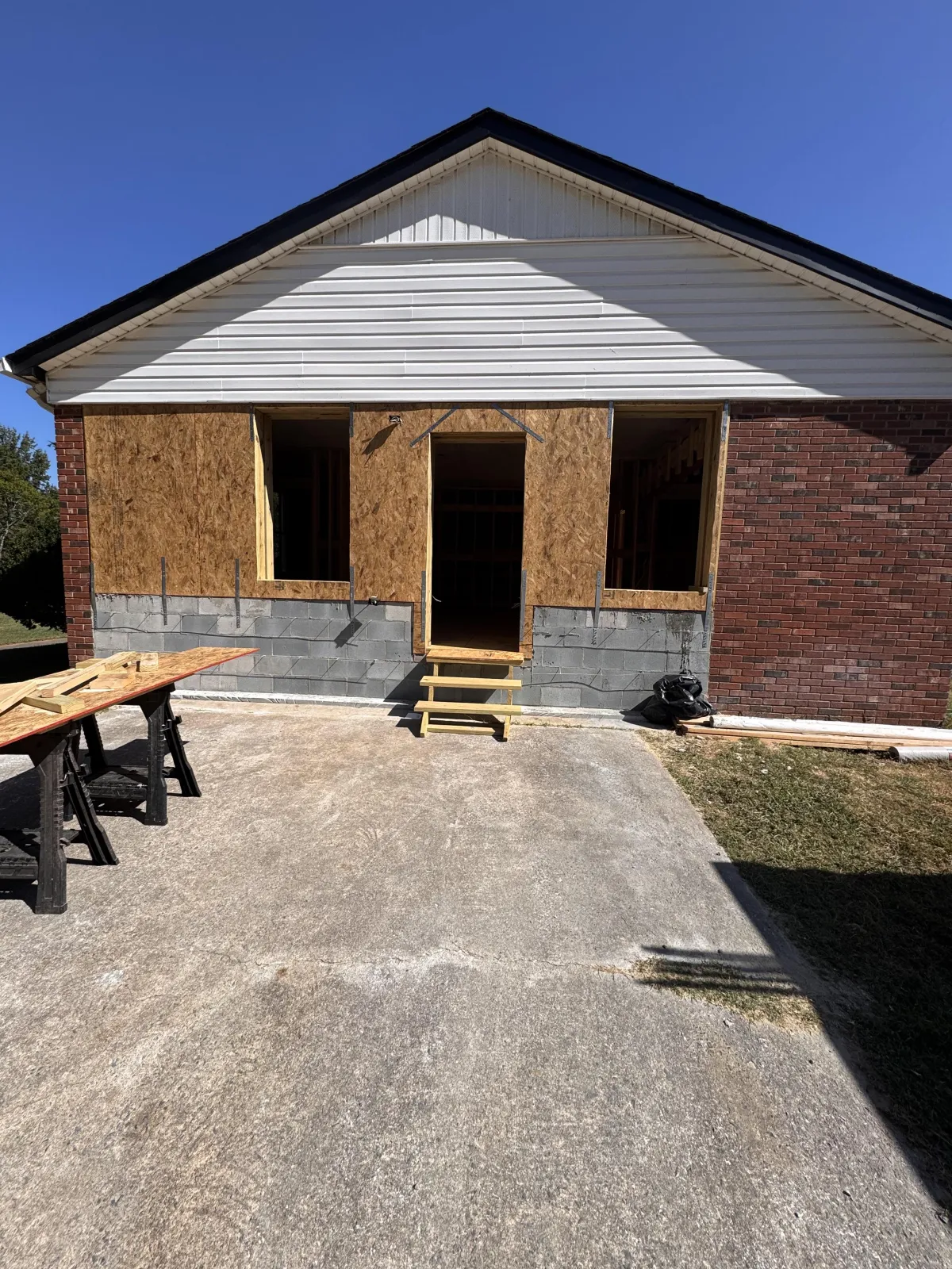 Front exterior remodel showing new front porch framing and construction work.