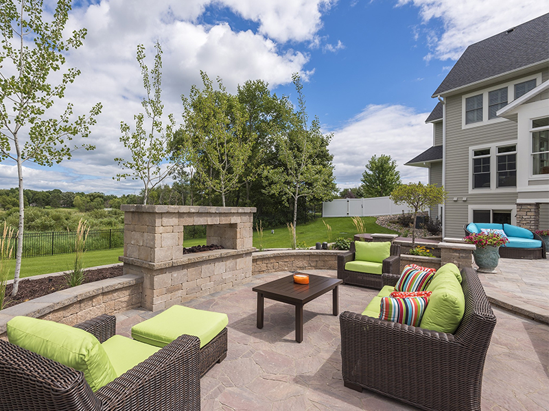 Backyard patio with outdoor seating, grill station, and modern hardscaping.