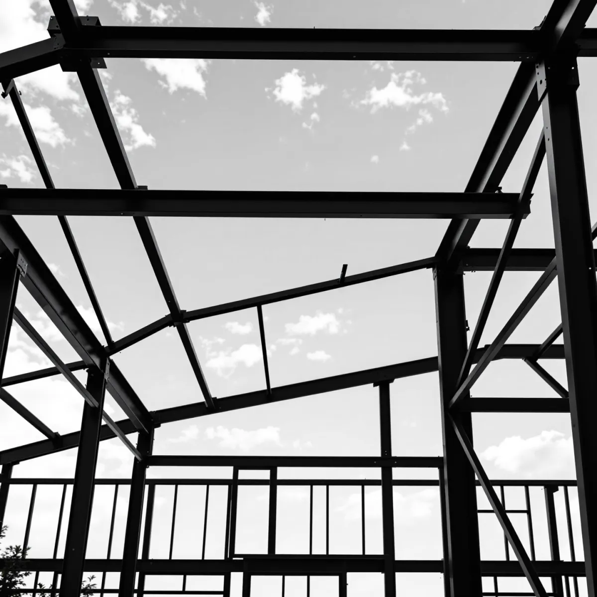 High-angle view of a steel mill production line with glowing billets and rolling equipment