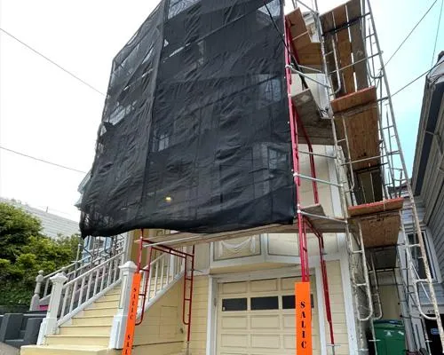 Construction scaffolding surrounding modern building