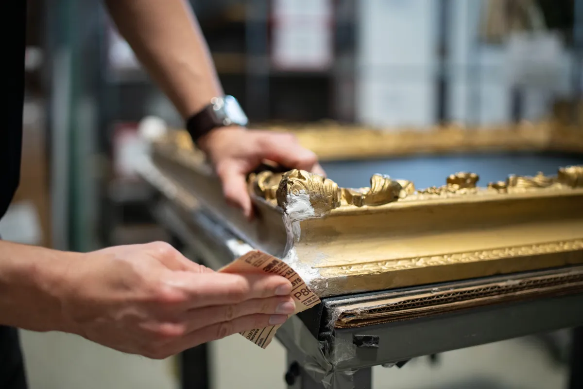 man in blue long sleeve shirt and black pants holding girl in black and white stripe