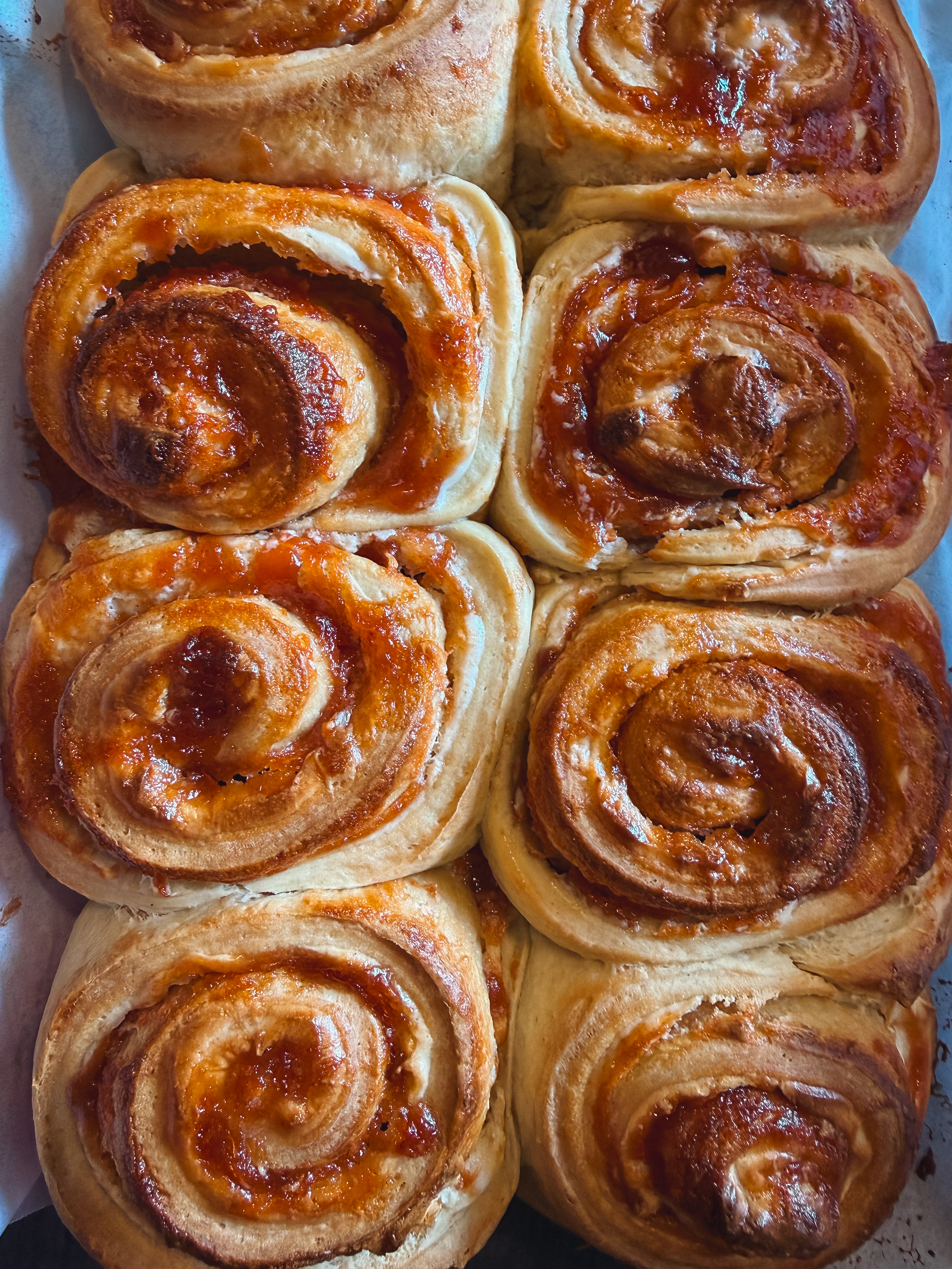 A bake sheet of sveral cinnmon rolls