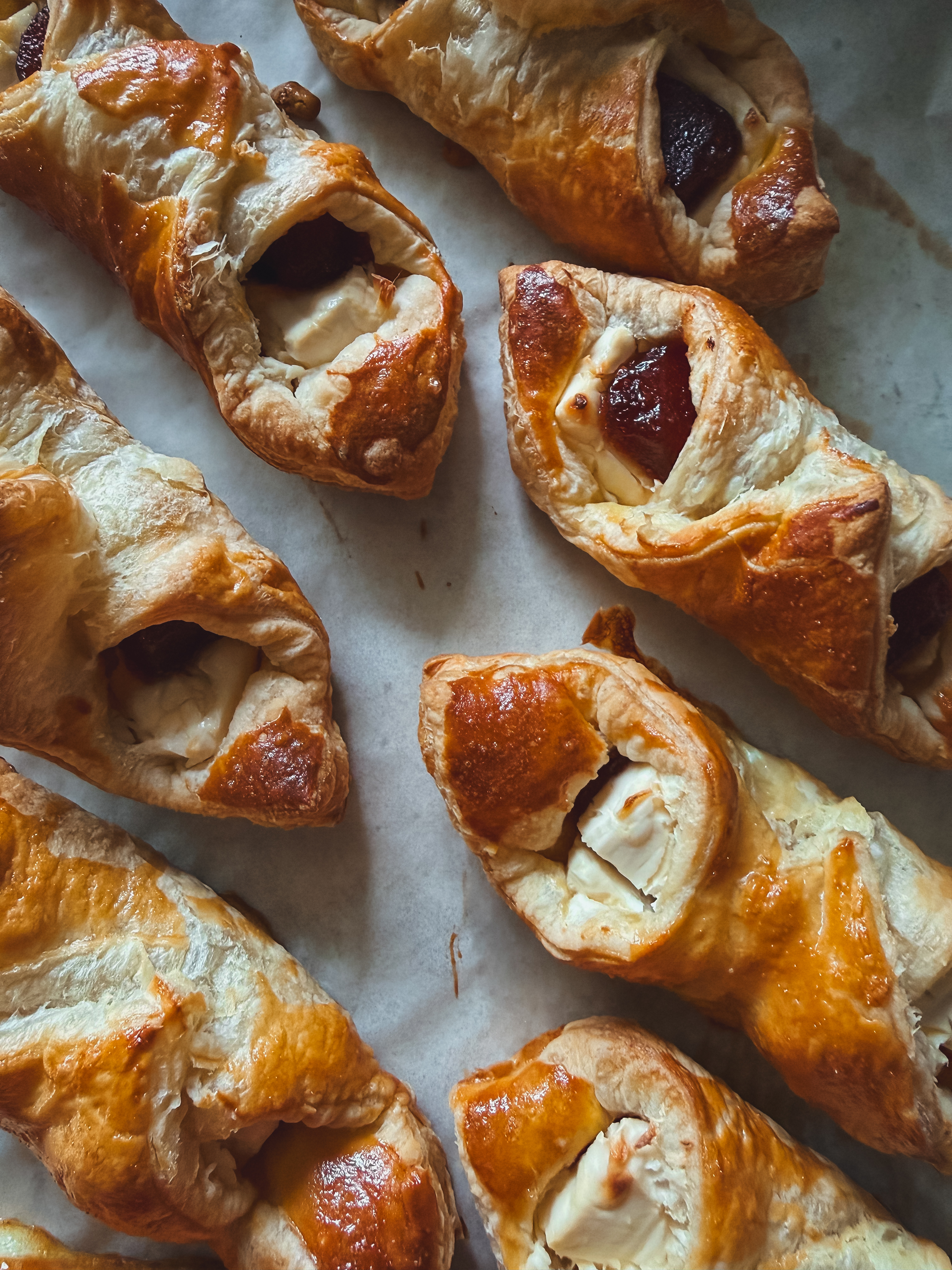 Bake sheet of several Pastelitos de guayaba - puff pastry wrapped around cream cheese and guava paste