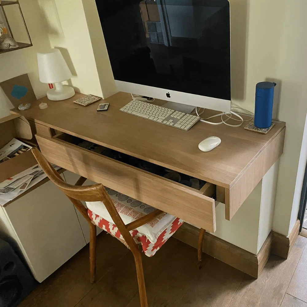 A bespoke desk with pull-out draw that we designed and installed