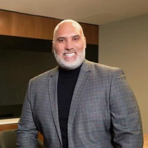 Portrait of founder and small team featuring people of color, warm professional tone