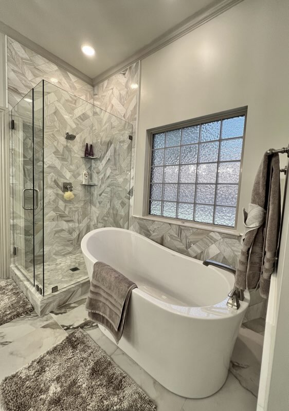 Bright kitchen remodel featuring white shaker cabinets, apron-front farmhouse sink, and marble countertops