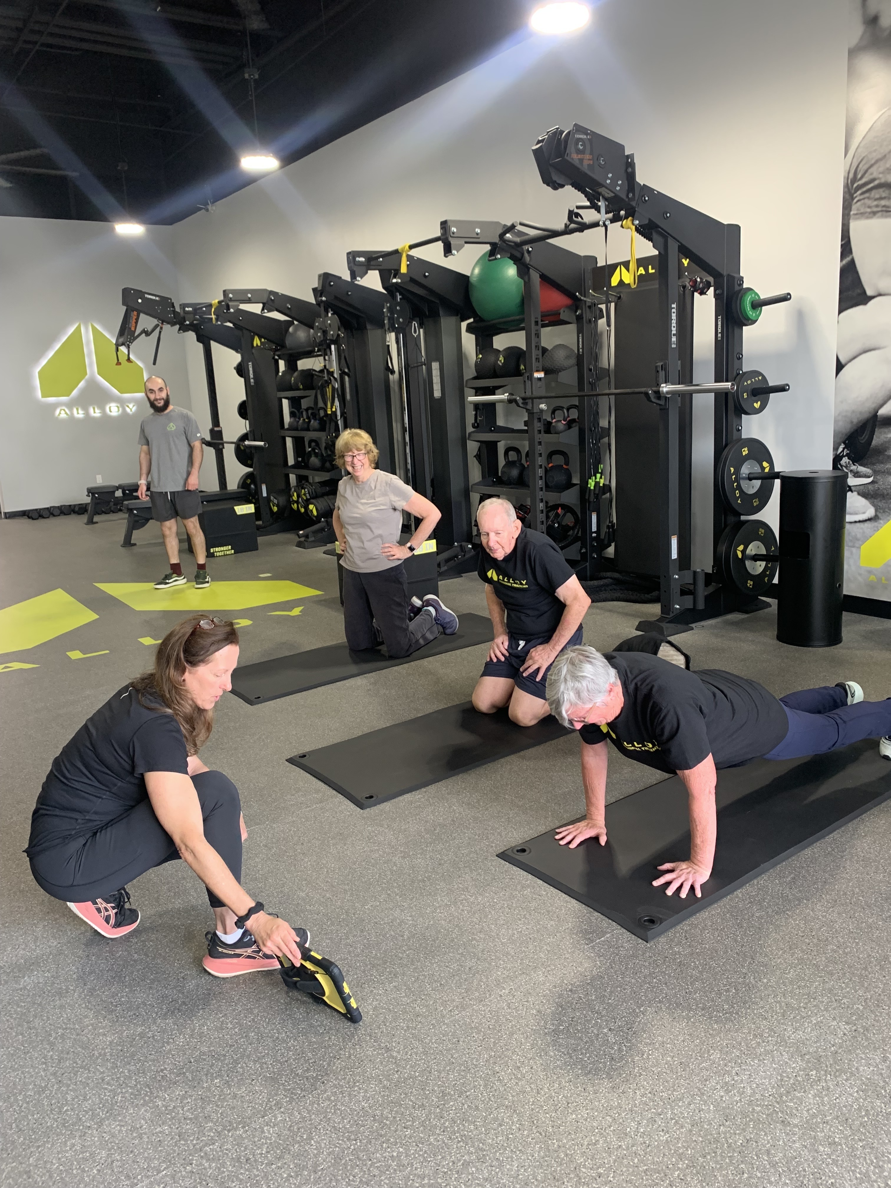 Small Group Personal Training Session Being Led by a Trainer in Planks at Alloy Personal Training East Pasadena