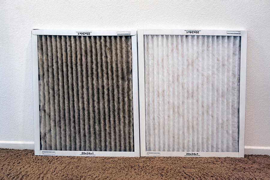 Technician performing scheduled air filter replacement service