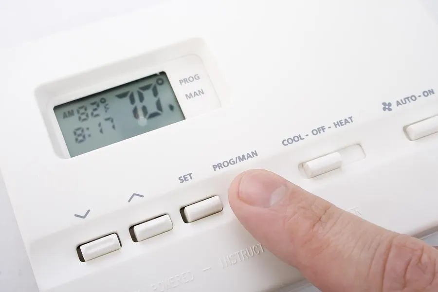 Modern thermostat controlling home heating and cooling system