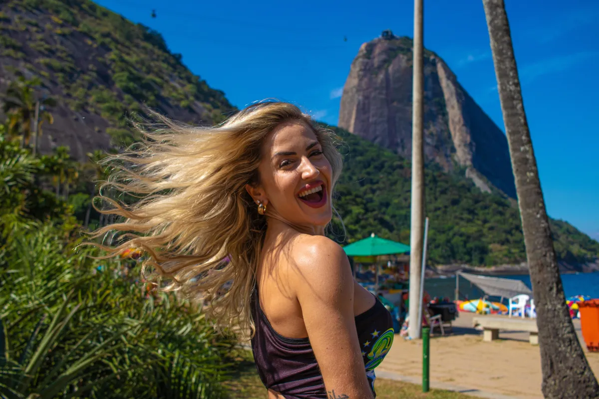 Happy woman at the beach, sugar loaf mountain, Rio de Janeiro, Brazil 
