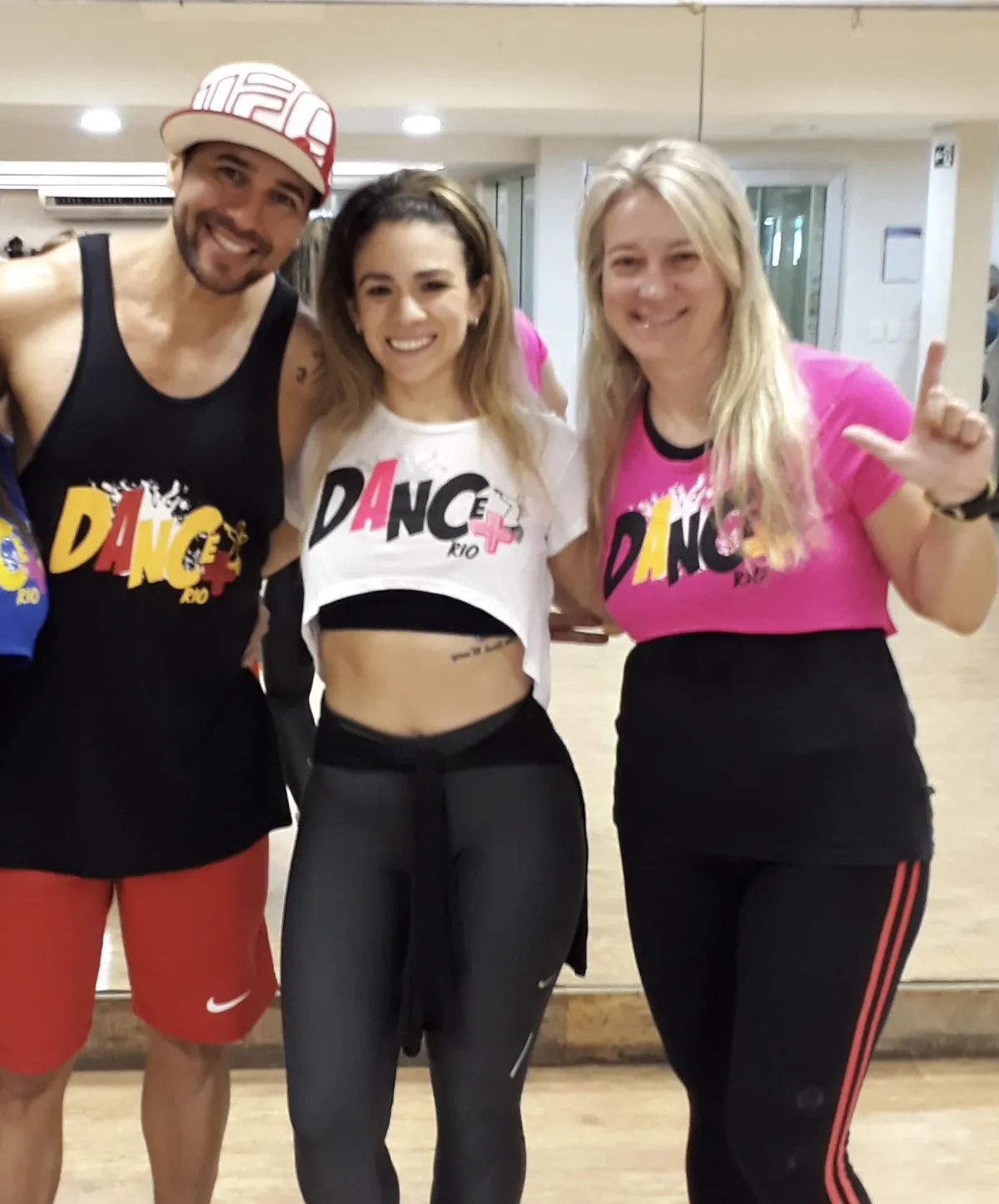two women and a man smiling together after Brazilian dance fitness class