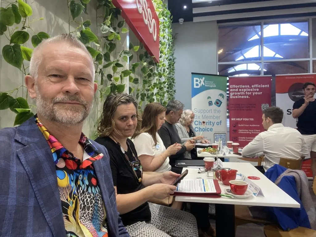 woman in black jacket sitting beside woman in white blazer