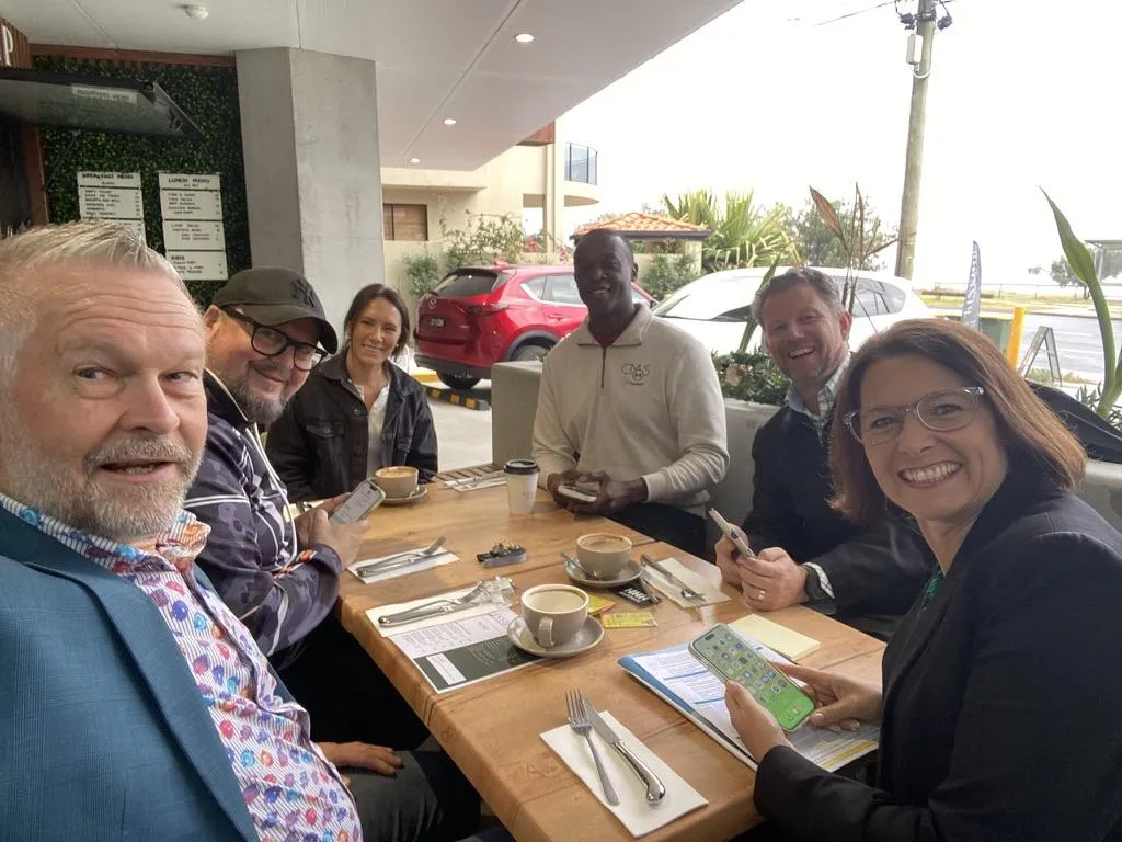 three men sitting on chair beside tables