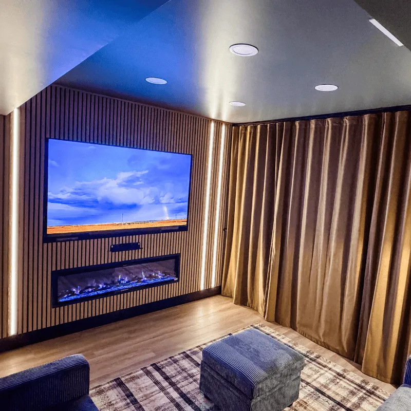 Movie room with mounted TV and built-in fireplace at Mallards Nest on Lay Lake