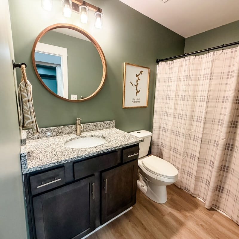 Modern bathroom with vanity and shower at Mallards Nest on Lay Lake vacation rental