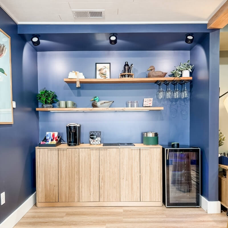 Coffee and wine bar with mini fridge and glassware in game room at Mallards Nest lake house