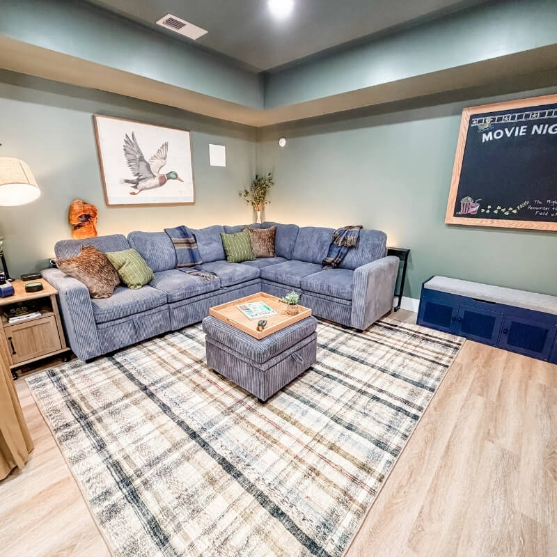 Private movie room with large smart TV, electric fireplace, and blackout curtains at Mallards Nest lake house