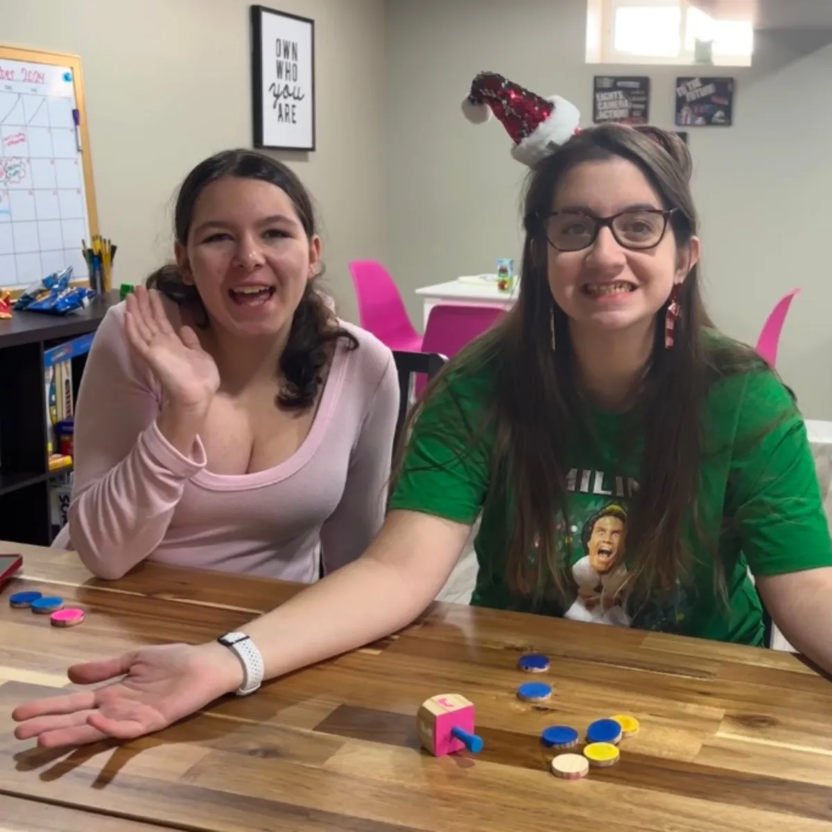 Two teen girls smiling and waving during the Friendship Confidence™ Program teen social group, building confidence and connection in Staten Island.