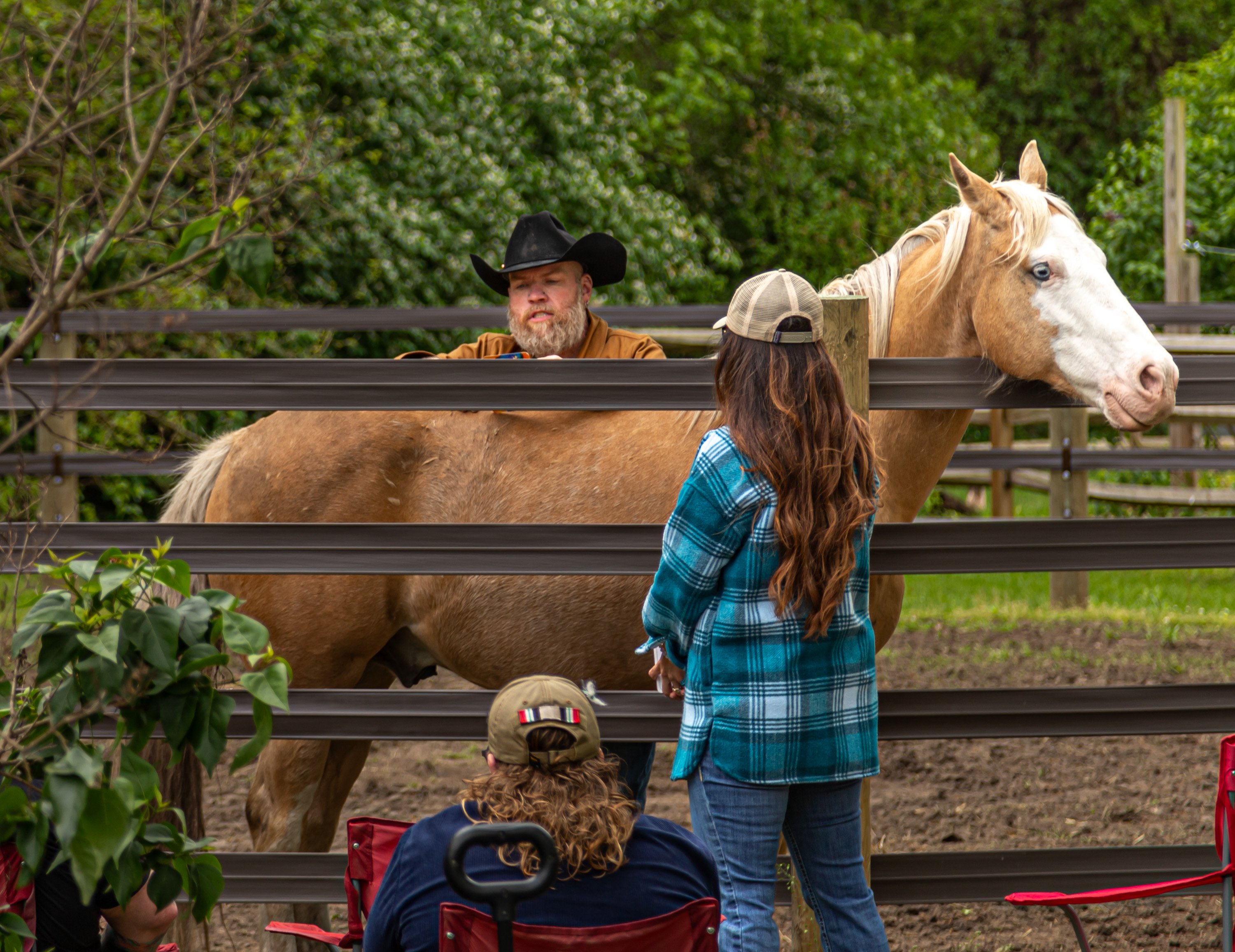 People hold a large rainbow flag during a parade.