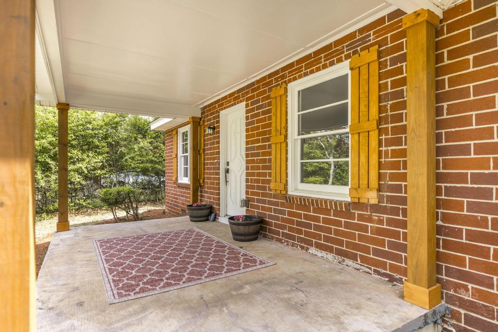 Get a cash offer on your home today. Renovated covered front porch with custom shutters.jpg